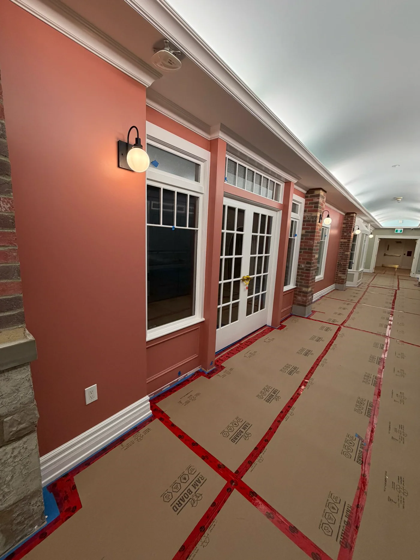 Terracotta corridor with crown molding and white trim