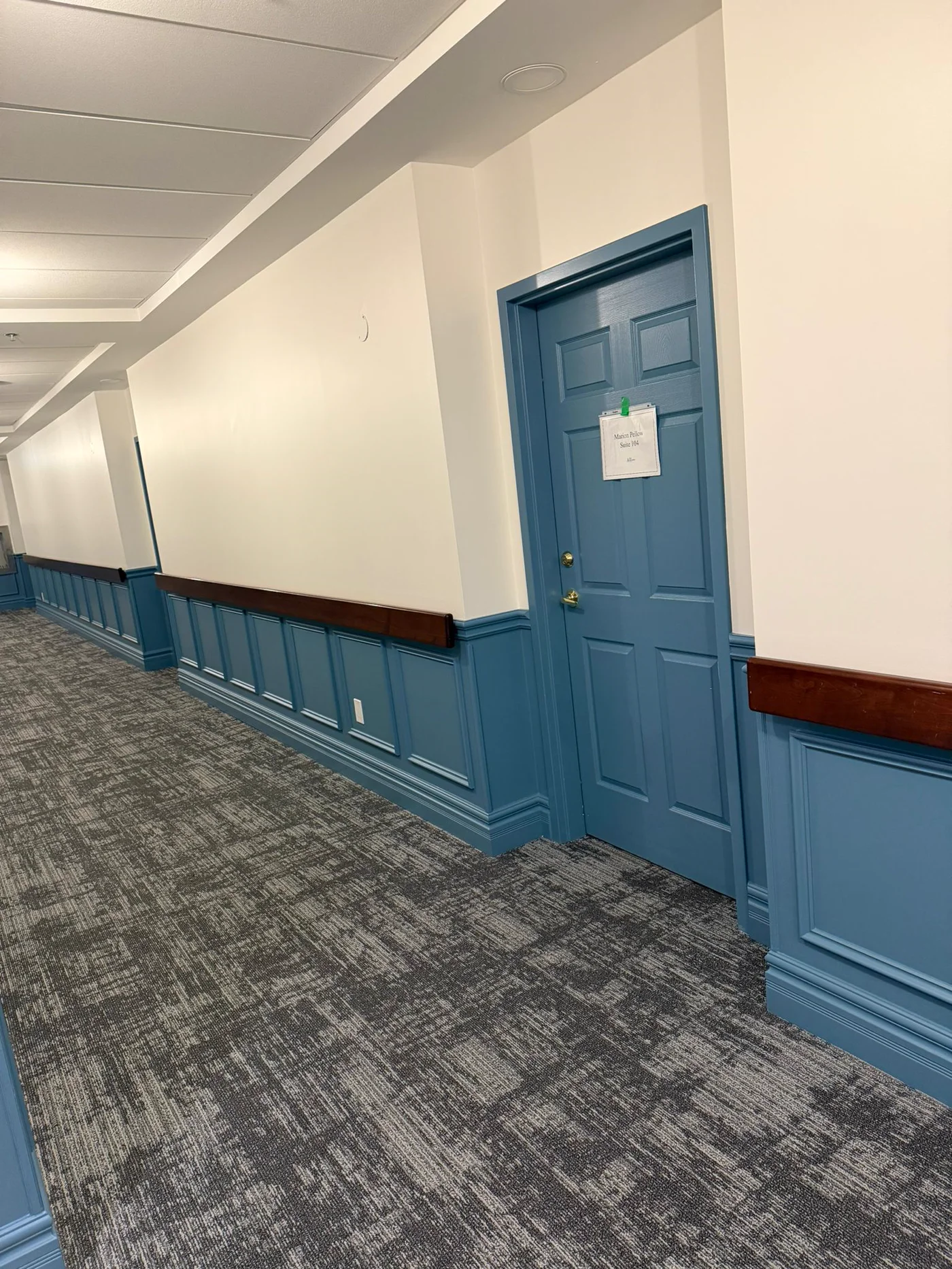 Stair hallway with two-tone blue wainscoting